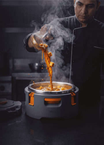 Chef serving hot curry into insulated food container